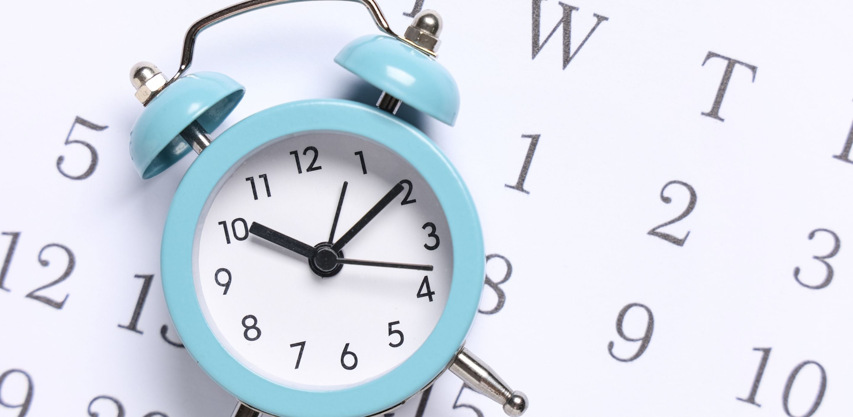 Clock with calendar in the background.