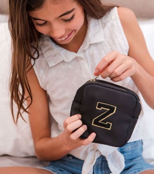 Tween holding Happy Tribe pouch