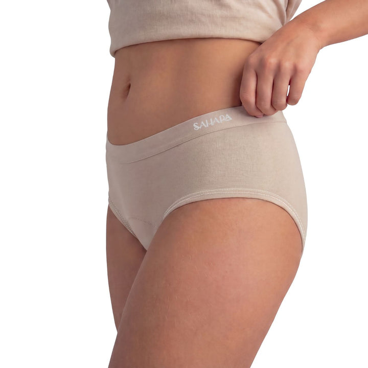 Teen wearing beige Sahara teen period pants - can be worn under white school uniform