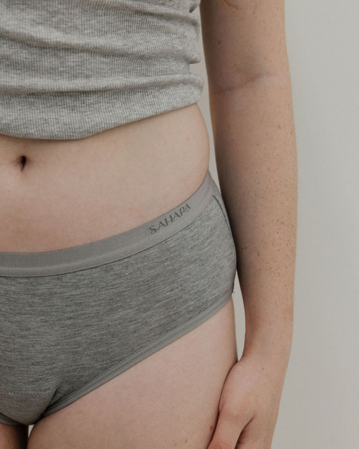 teen wearing grey period pants - close up