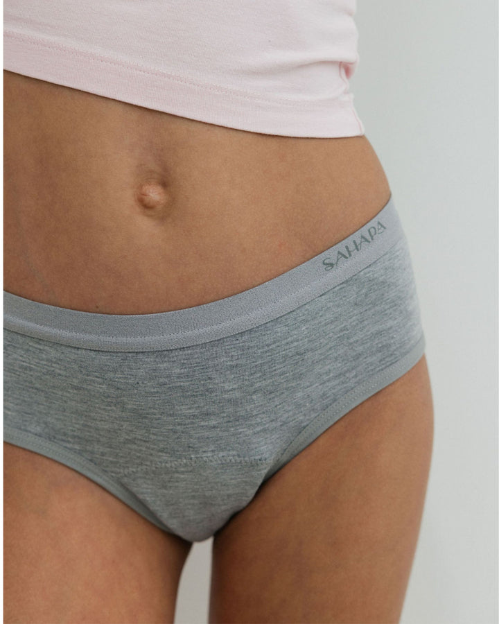 tween wearing grey period pants